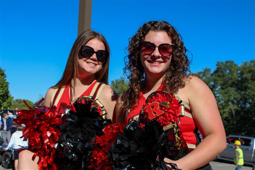 Two students smile on a float